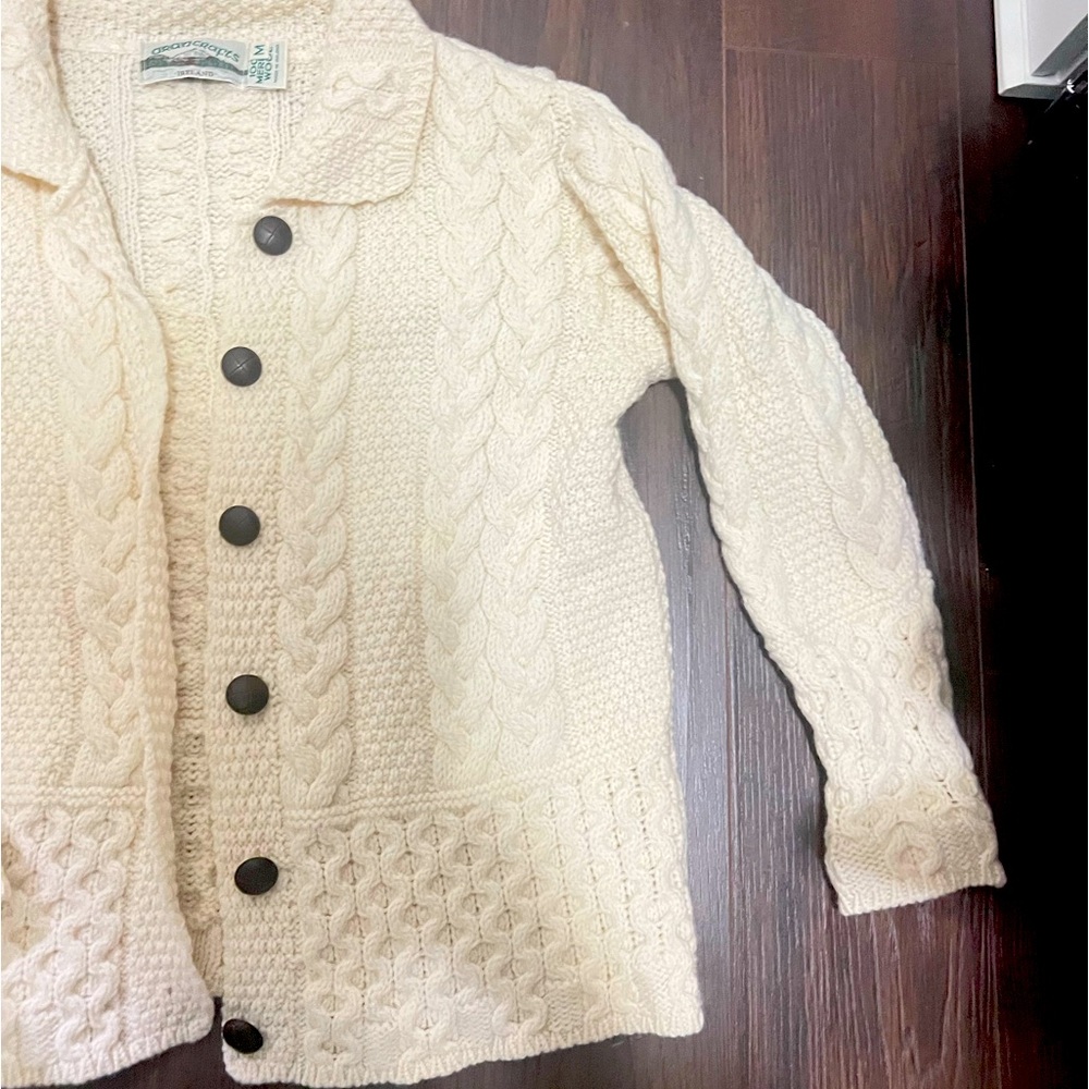 This is a vintage cream-colored Aran knit sweater made from pure new wool.